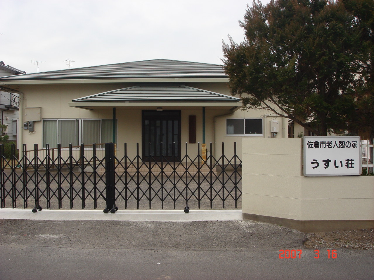 「佐倉市老人憩の家 うすい荘」と書かれた看板がある外壁がクリーム色の、うすい荘の写真