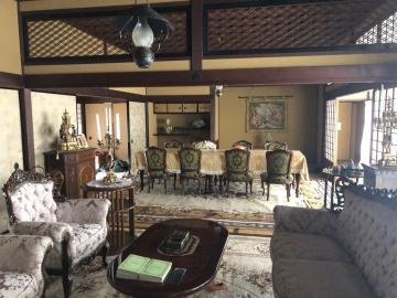 アンティークなテーブルや椅子が置かれ、手前には応接セットの椅子とテーブルが置かれている旧堀田邸の室内写真