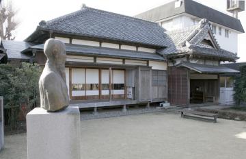 庭園内に銅像が建っておりその奥に佐倉順天堂記念館が見える写真